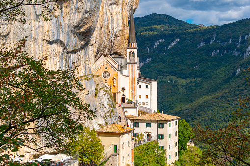 View from the mountain hiking trail of the Santuario de la Madonna della Corona, a picturesque historic mountainside church built in 1625 in Spiazzi, Italy.