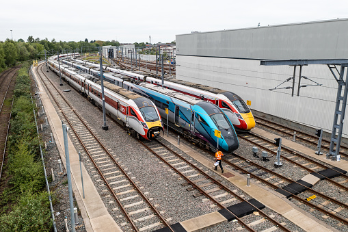 Doncaster, UK - May 13, 2023.  Aerial view of a fleet of Hitachi high speed passenger trains in Trans Pennine Express and LNER livery on the Hitachi Maintenance Depot in Doncaster