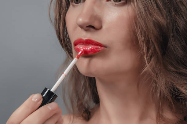 istock Close-up of female lips, applying red lipstick 1492397066
