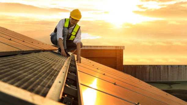 istock Engineer working setup Solar panel at the roof top. Engineer or worker work on solar panels or solar cells on the roof of business building 1492399434
