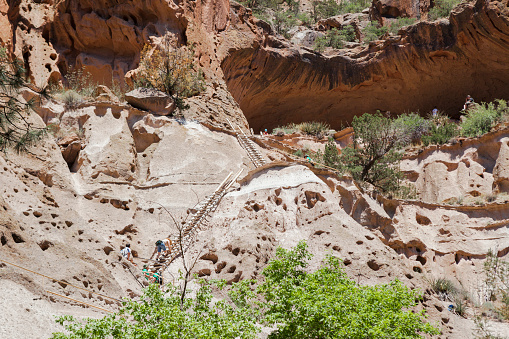 Bandelier National Monument, New Mexico, USA - June 7, 2012. Tourists climbing the ladder to Alcove House at Bandelier National Monument in New Mexico, USA.