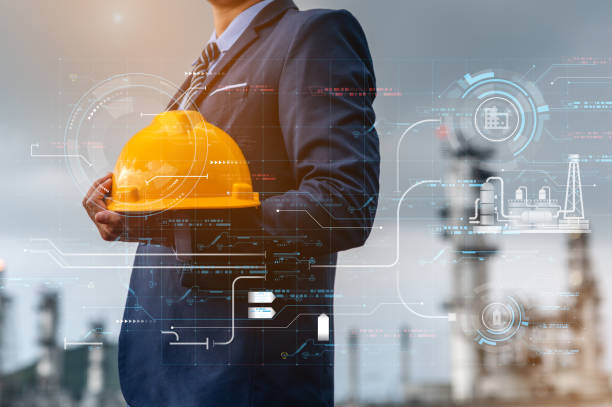 istock Engineer and architect supervising work inside a large oil refinery, he holds a yellow helmet in his hand.Architect is building structure of oil refinery, architect and refinery industry concepts. 1492404721