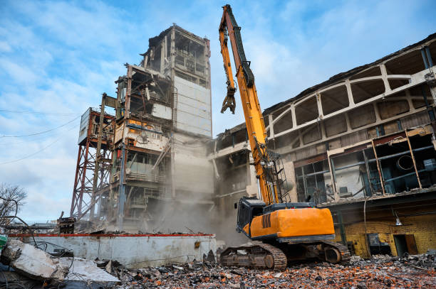istock Disassembling of old industrial building by high excavator 1492409153