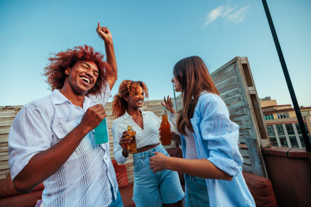 istock Group of three multiracial friends dancing on daytime party. 1492411433