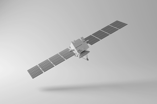 White communication satellite floating in mid air casting shadow on white background creating greyscale monochrome. Illustration of the concept of space technology