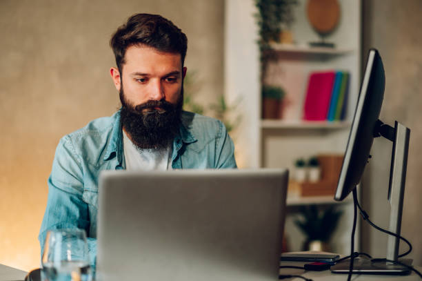 istock A data entry scientist is sitting at the home office at night and paying extra attention to his clean code on a laptop. 1492414097