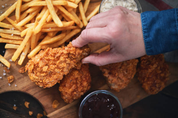 istock Crispy Fried Chicken Drumsticks with French Fries 1492416460