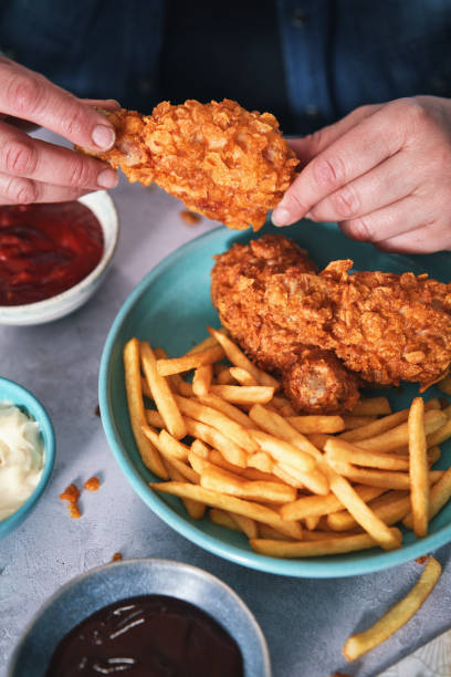 istock Crispy Fried Chicken Drumsticks with French Fries 1492416526