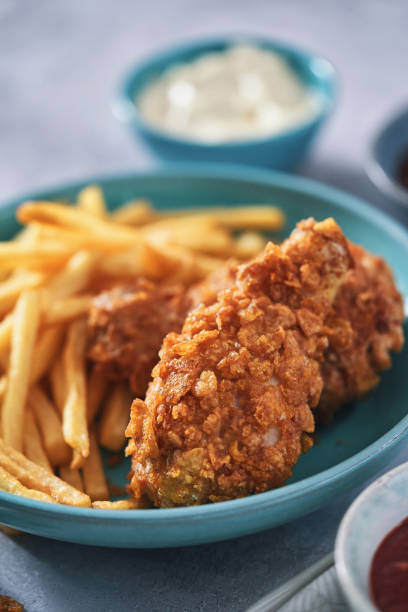 istock Crispy Fried Chicken Drumsticks with French Fries 1492416537