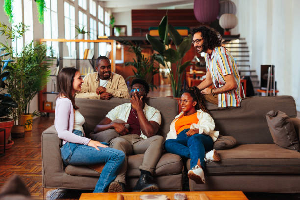 istock Diverse group of five young people having conversation in living room 1492416645