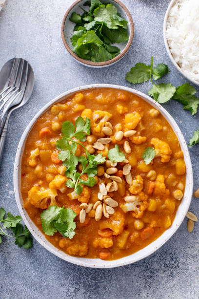istock Cauliflower curry with peanuts and cilantro in a bowl 1492418950