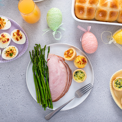 Ham, asparagus and mini quiches for Eater brunch served on a plate