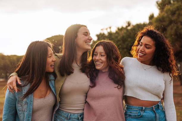 istock Group portrait of four multiracial young girlfriends walking together. 1492420676