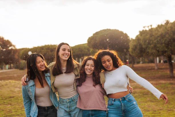 istock Four interracial young friends walking and smiling together. 1492420691