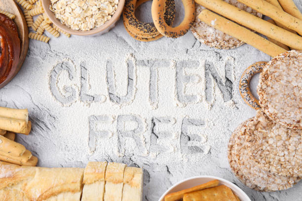 istock Different products and phrase Gluten free written with flour on light grey table, flat lay 1492420938