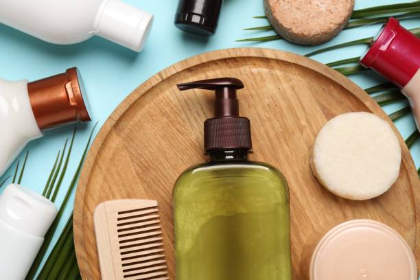 istock Shampoo bottles, wooden comb, hair mask and solid shampoo bars on turquoise background, flat lay 1492422350
