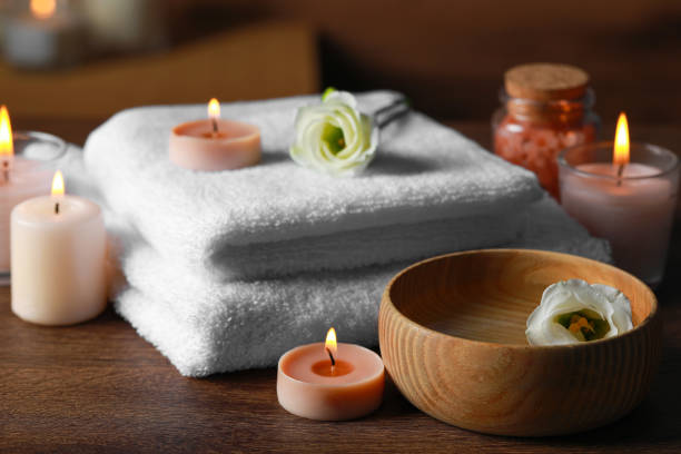 istock Beautiful spa composition with burning candles and flowers on wooden table 1492422426
