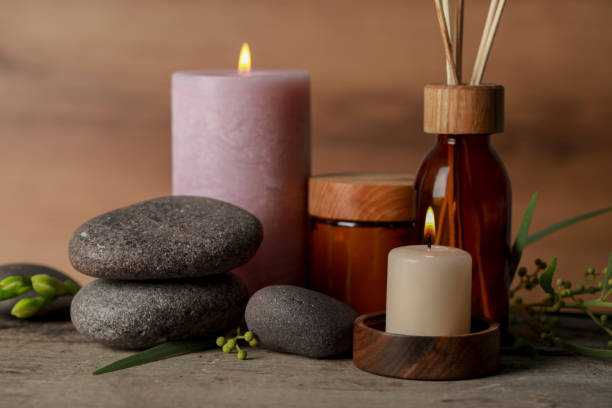istock Beautiful spa composition with different care products and burning candles on wooden table, closeup 1492422433