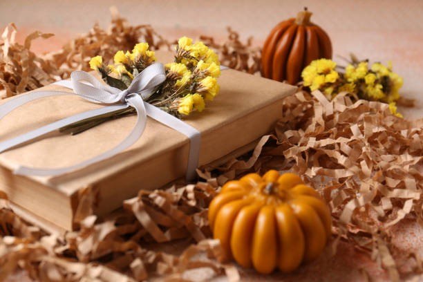 istock Book decorated with flowers on beige textured table, closeup 1492422449
