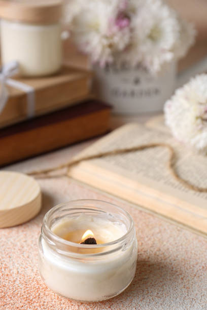 istock Burning candle on beige textured table, closeup 1492422467