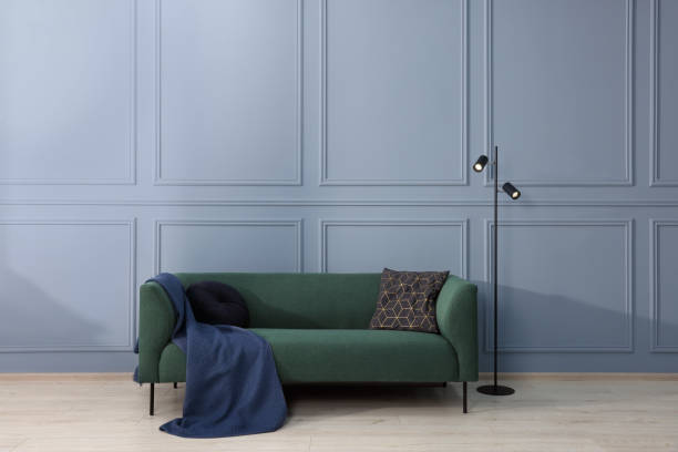 istock Comfortable sofa with blanket and cushions in light room. Interior design 1492422540