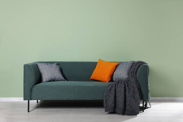 istock Comfortable sofa with decorative cushions and blanket indoors 1492422569