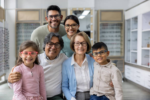 Happy multi-generation family wearing glasses at the opticians shop Happy Latin American multi-generation family wearing glasses at the opticians shop group of people wearing eyeglasses stock pictures, royalty-free photos & images