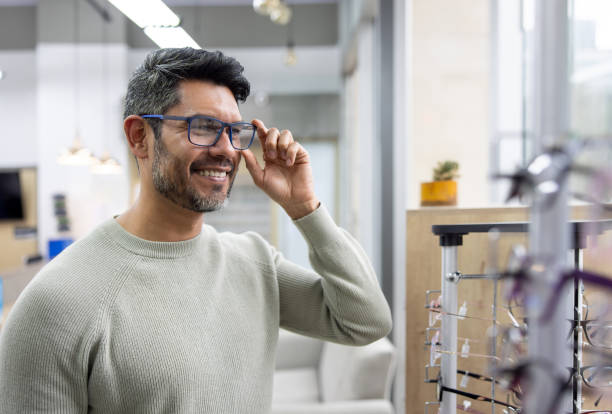 Man trying on new glasses at the optician store