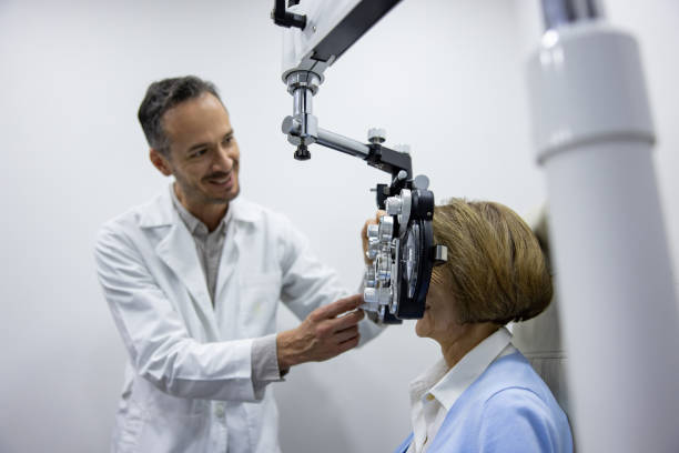 istock Happy optometrist doing an eye exam on a senior woman 1492424581