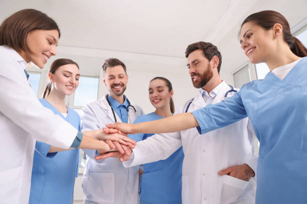 istock Team of medical doctors putting hands together indoors 1492425505