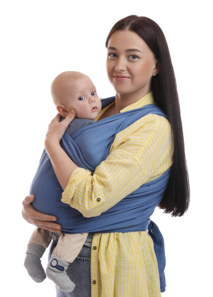 istock Mother holding her child in sling (baby carrier) on white background 1492425608