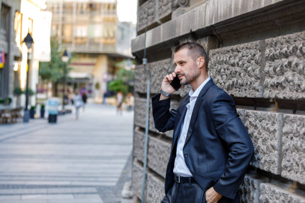 istock A Young Businessman in Hurry to Going to the Office and Using a Mobile Phone While Walking in City Street. 1492428589