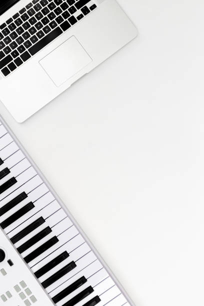 istock Musical keys and a laptop on a white background, top view, minimalism. 1492429897
