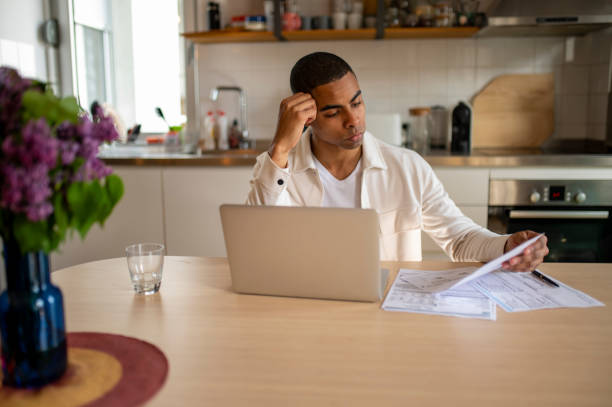 istock Worried African American man looking at his bills 1492434084