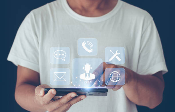 istock Technical Support Center Customer Service Internet Business Technology Concept. Person hand using smartphone with virtual screen support customer icon, it support, call center, customer service help. 1492437484