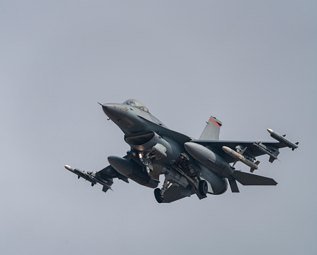 Beja, Portugal: parked General Dynamics F-16 Fighting Falcon of the Portuguese Air Force - Jaguars Squadron, with NATO logo on vertical stabilizer - equipped with external fuel tanks - Beja Airport serves both civil and military aviation.