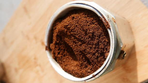istock Coffee powder, slanted angle, close-up shot. Ground coffee beans inside the coffee pot. Making black coffee in the Italian coffee maker. Coffee cup preparation 1492440571
