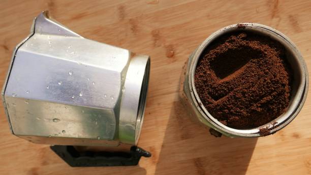 istock A moka pot on the table. Coffee powder, close-up shot. Ground coffee beans inside the coffee pot. Making black coffee in the Italian coffee maker. Coffee cup preparation 1492440607