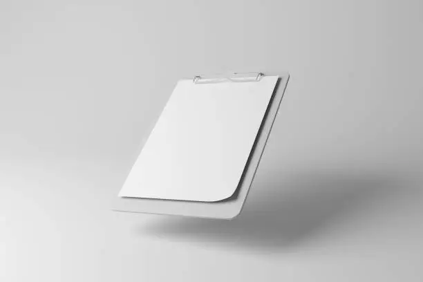 Photo of White clipboard floating in mid air with shadow on white background in greyscale monochrome. Illustration of the concept of investigation, commercial questionnaires and surveys