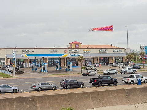 Galveston, TX - USA, April 26, 2023. A typical strip mall along Seawall boulevard on Galveston island of the gulf coast. Selling everything from gasoline to kites along the touristy section along the road of Galveston island.