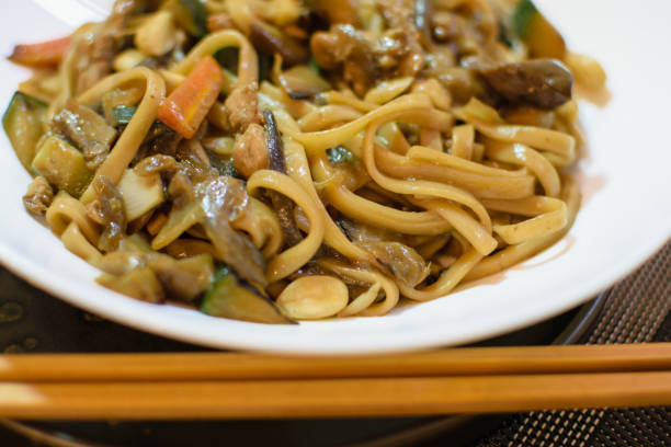 istock Rice noodles served with vegetables and meat in white bowl. 1492442429
