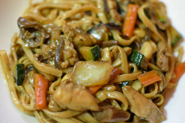 istock Rice noodles served with vegetables and meat in white bowl. 1492442526