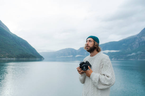 istock Man photographing Norwegian scenic landscape 1492445335