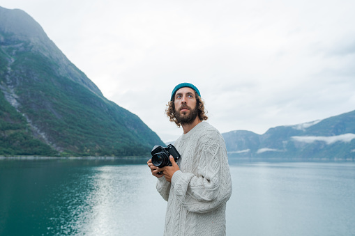 Man photographing Norwegian scenic landscape