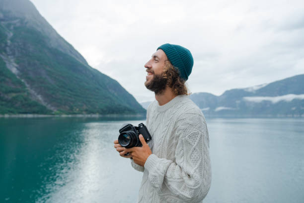 Man photographing Norwegian scenic landscape