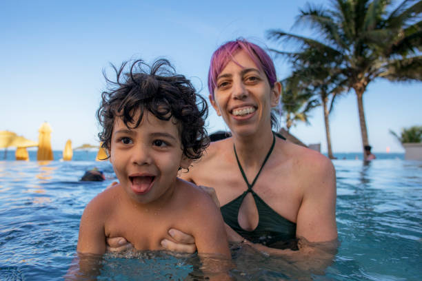 istock mother with children in the pool 1492449006