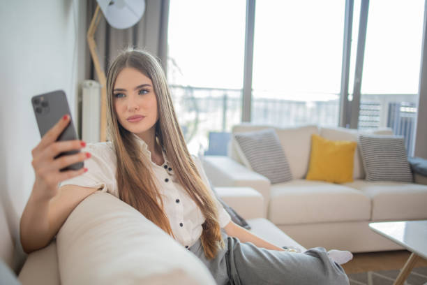 istock Happy young woman using phone 1492456184