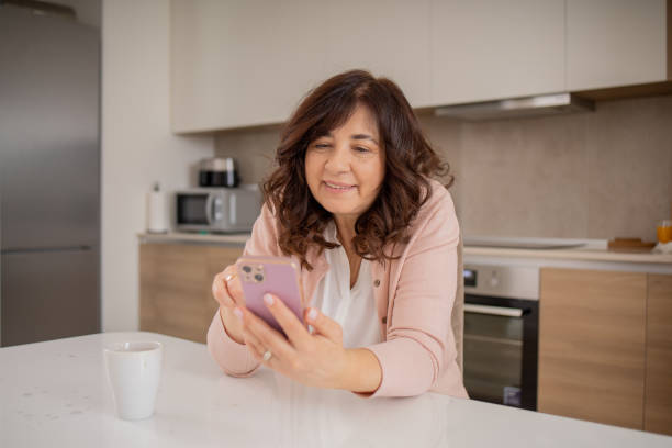 istock Happy mature woman using phone 1492456486