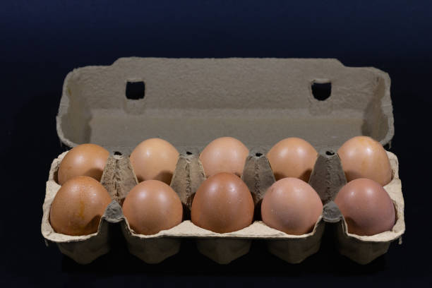 istock Studio shots of an isolated eggs box on a black background containing brown eggs, ra and organic, ready to be cooked. 1492460060