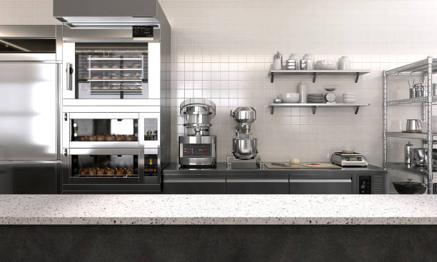 istock Empty clean white terrazzo top island table counter in commercial, professional bakery kitchen, stainless steel convection, deck oven, freezer, refrigerator, shelf, cabinet, bread 1492460520